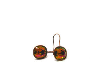 Beautiful crystal sparkling stones set in a brass base setting. The stone is faceted with brown, amber, green, and orange hues.
